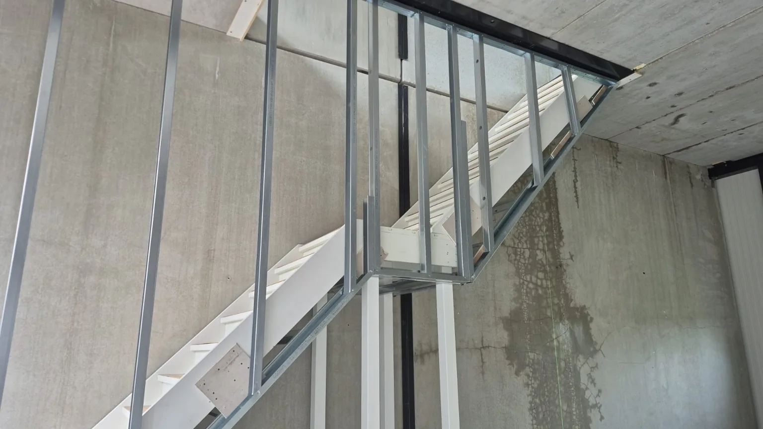Metal stud framing around staircase at Zoetermeer project